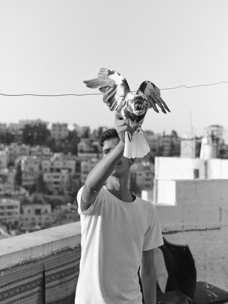 © Hamzeh Zahran - A Man and His Pigeon, Amman, 2025, from the "Remains" series