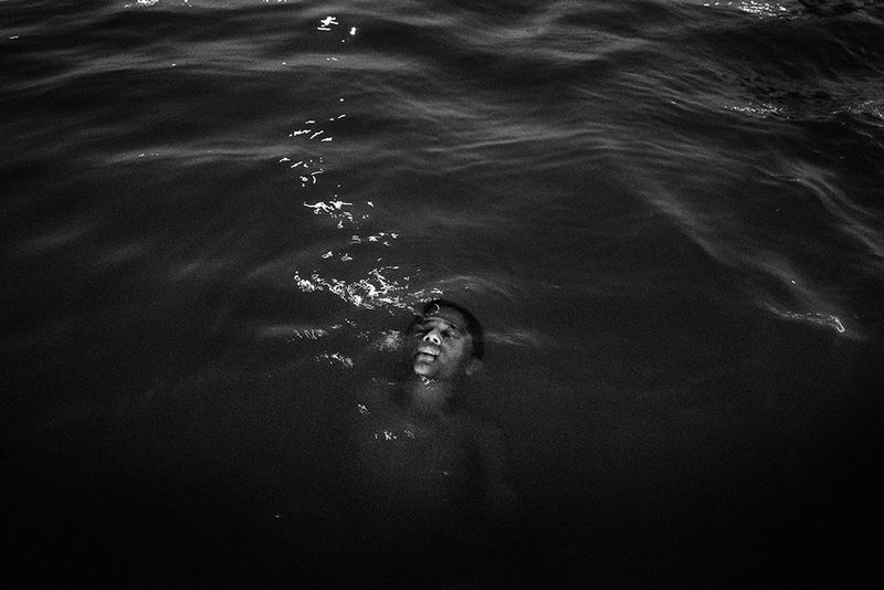 © Tommaso Protti - A boy taking a bath at night in the Tocantins river, a tributary of the Amazon River in the state of Pará.