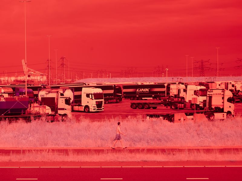 © Anton Bossenbroek - Trucks waiting to be loaded or to drive on Monday on a hot Sunday in 2023 on the Maasvlakte in the harbor of Rotterdam.