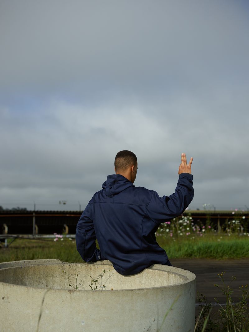 © Anton Bossenbroek - Riyaan making the hand gesture to flag the minibus to Sasol 3 plant, Secunda, 2025