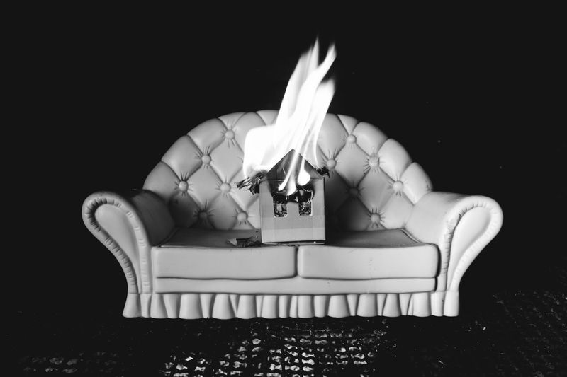© Nadia Ettwein - The house was on fire, 2025. Constructed image of a toy couch and a burning house. Respectfully burning.