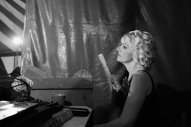 © Lieh Sugai - Miss Natalie, the ringmaster, watches the performance behind the stage. She also presents her dogs as part of the show.