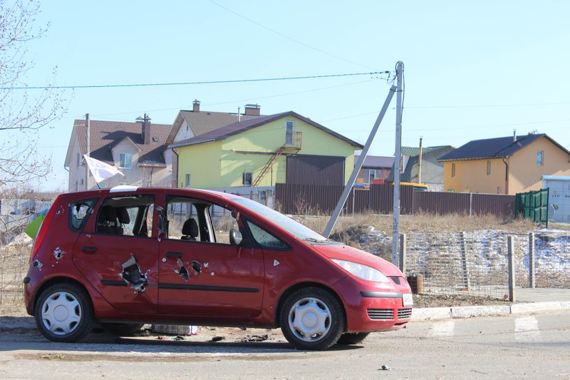 © Ira Sozanska - Reminder in redA  shot-up car on the road in Bucha. We passed this road during evacuation. We survived. Not everyone did.