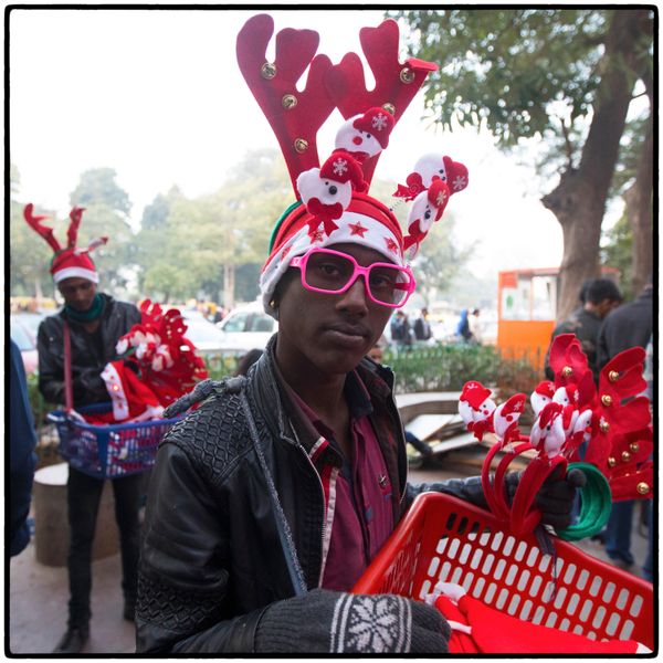 © Vijay S. Jodha - Two youngsters selling various Christmas headgear.