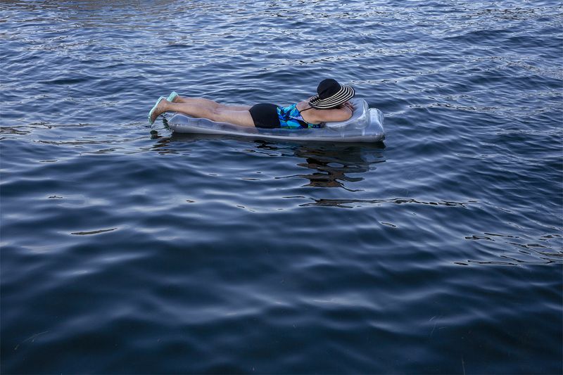 © Rachel Jessen - A woman floats on West Okoboji Lake. (Dickinson County)