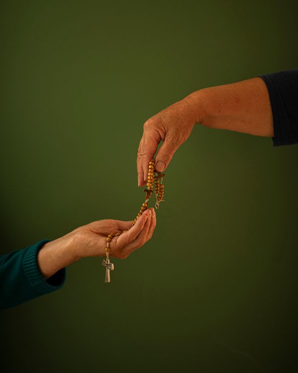 © Margarita V Beltran - Rite My aunt offers a rosary to my mother.