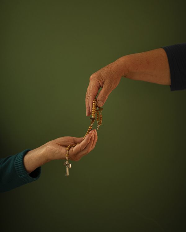 © Margarita V Beltran - Rite My aunt offers a rosary to my mother.
