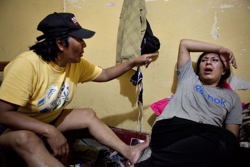 © Danielle Villasana - After many hours of drinking, Tamara, right, and her mother Evila, left, argue about her work on the streets.