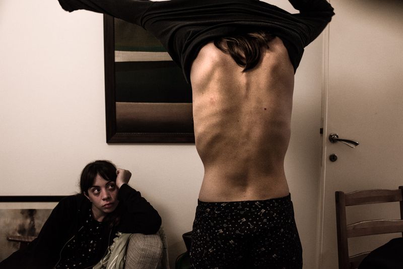 © Maria Giulia Trombini - M., hunger striker, goes to sleep while G. takes care of her, Rome.