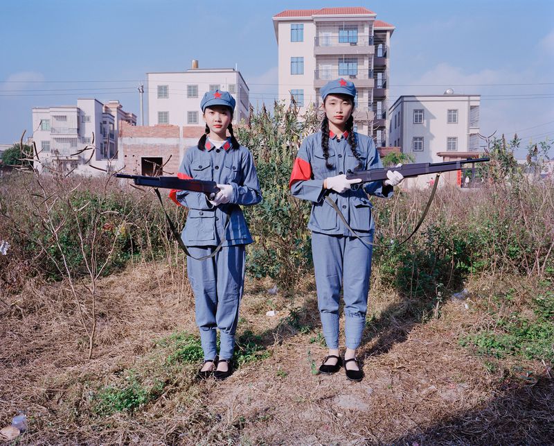 © liang chen - Two young women playing the role of "soldiers". Zhanjiang, Guangdong, China 2023