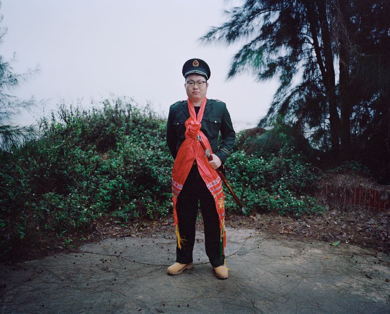 © liang chen - A young man plays the role of a Chinese officer. 2023 Donghai Island, Guangdong Province, China