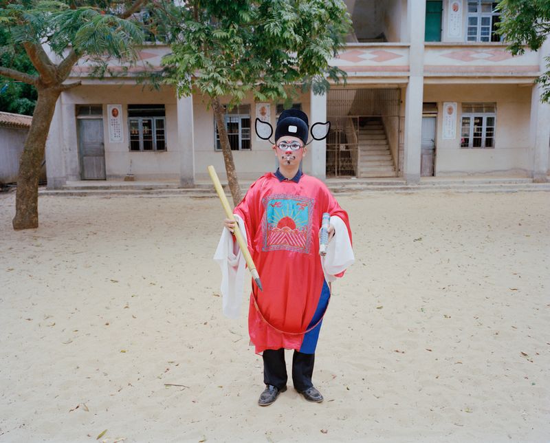 © liang chen - Youth playing the role of ancient Chinese "judge"  2014  Donghai Island, Guangdong, China