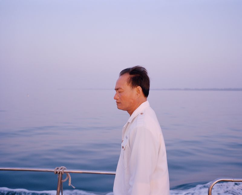 © liang chen - The man who left his hometown by boat.  2014  Donghai Island, Guangdong Province, China