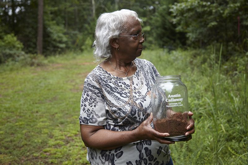© Richard Ansett - Frances holds the memorial jar as she watches Walter collect soil