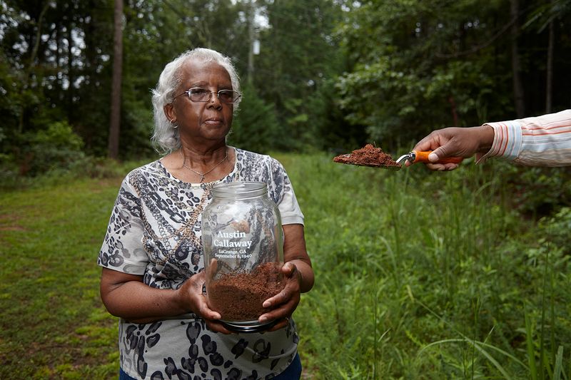 © Richard Ansett - Frances assists Walter in collecting soil for the memorial jar