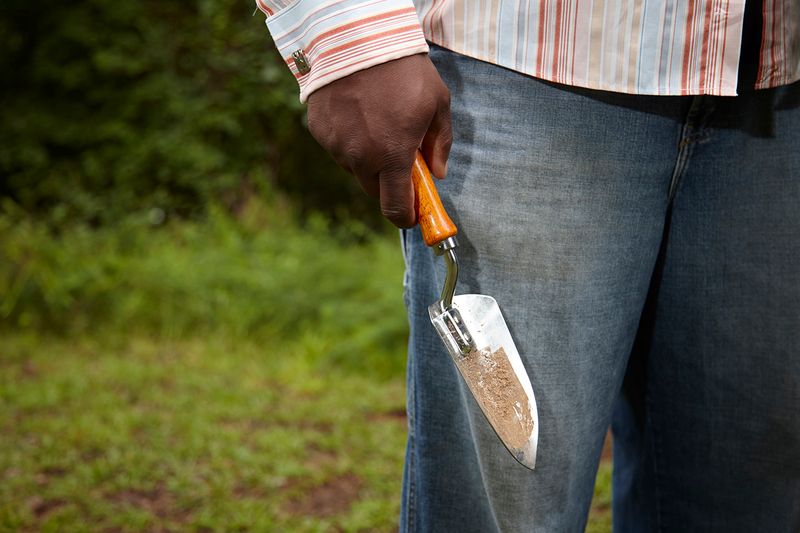 © Richard Ansett - Walter with trowel prepares to collect soil for the EJI memorial jar