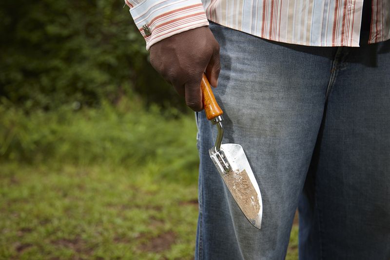 © Richard Ansett - Walter with trowel prepares to collect soil for the EJI memorial jar