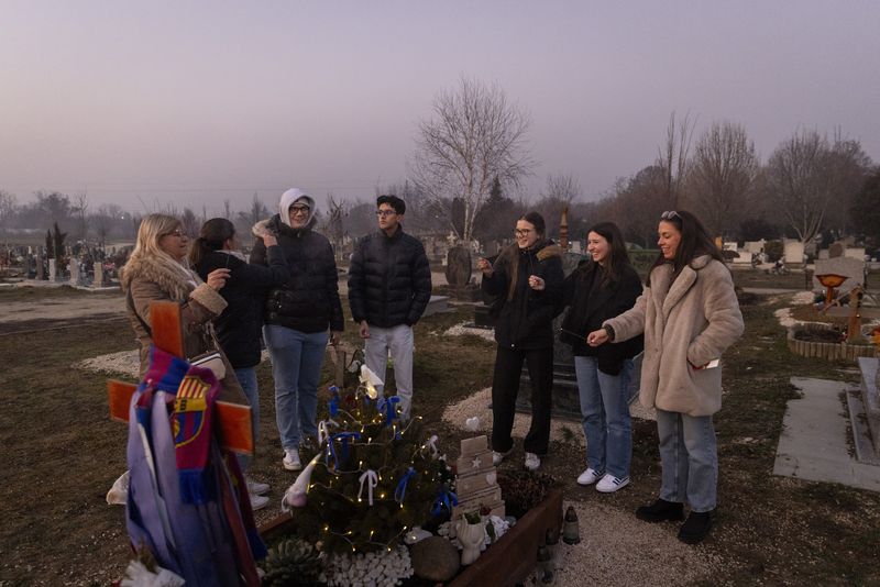 © Noémi Napsugár Melegh - My mother, sister, and my brother's friends at my brother's grave during the first Christmas after his passing.