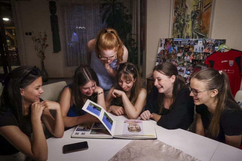 © Noémi Napsugár Melegh - His friends are looking at the book which has all their memories with my brother.