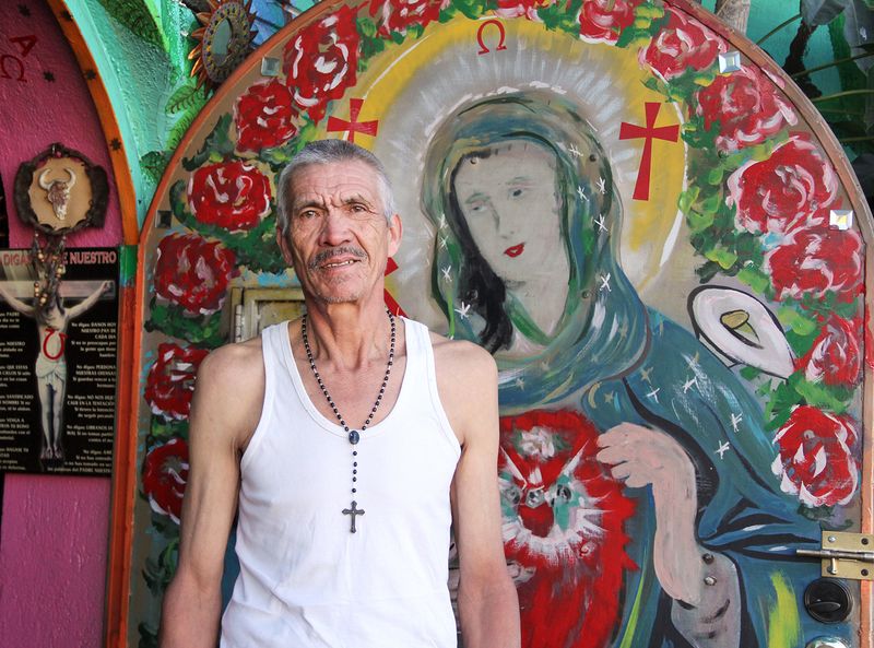 © Julie Grace Immink - Man in front of religious shop
