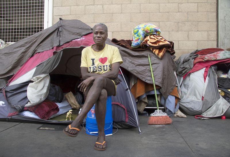 © Julie Grace Immink - Woman in front of her house on skid row