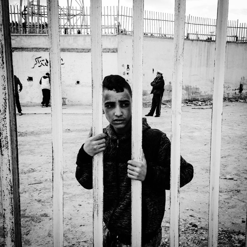 © Fethi Sahraoui - A young boy begging for money to buy a ticket,the price of a ticket is around 2$.