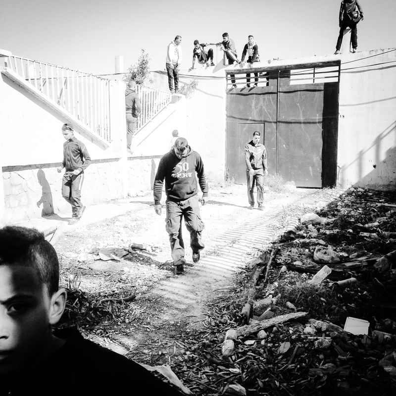 © Fethi Sahraoui - Supporters from all age categories escaping riots police after a missed try to jump the wall of the stadium.