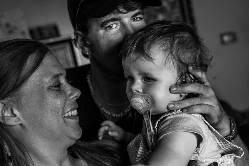 © Jared Ragland - Jennifer and her boyfriend Jason with a neighbor's child.