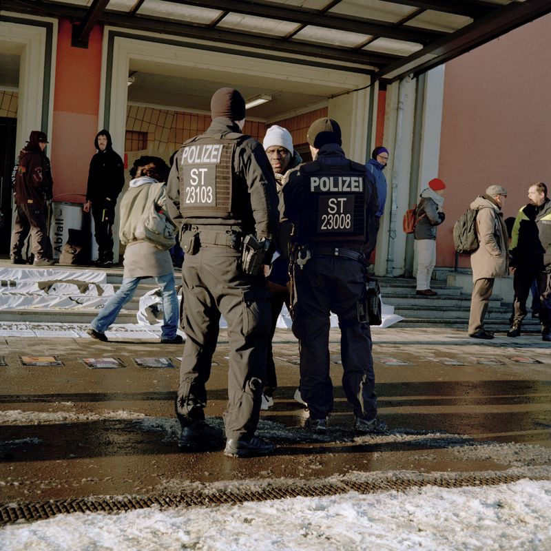 © Oscar McQuillan-Byrne - Police question organisers of Oury Jalloh memorial demonstration outside Dessau train station. Dessau, Germany.