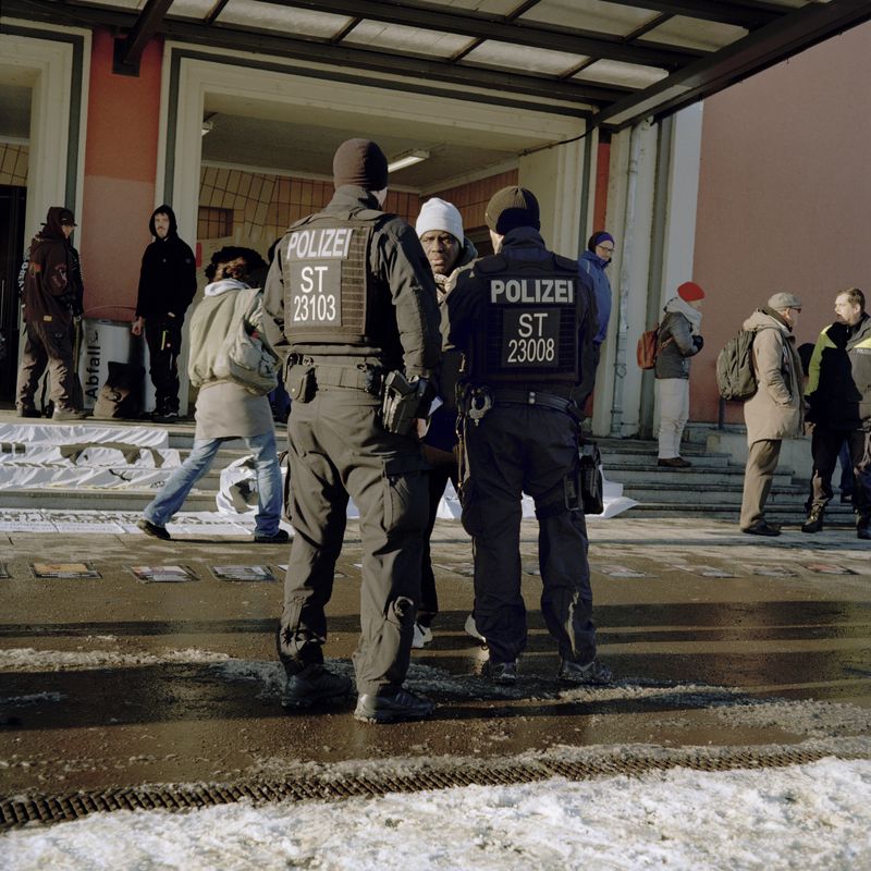 © Oscar McQuillan-Byrne - Police question organisers of Oury Jalloh memorial demonstration outside Dessau train station. Dessau, Germany.