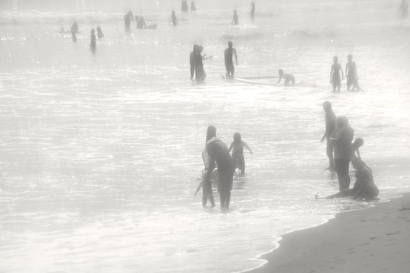 © Angela Galia - Families gather playing by the ocean.