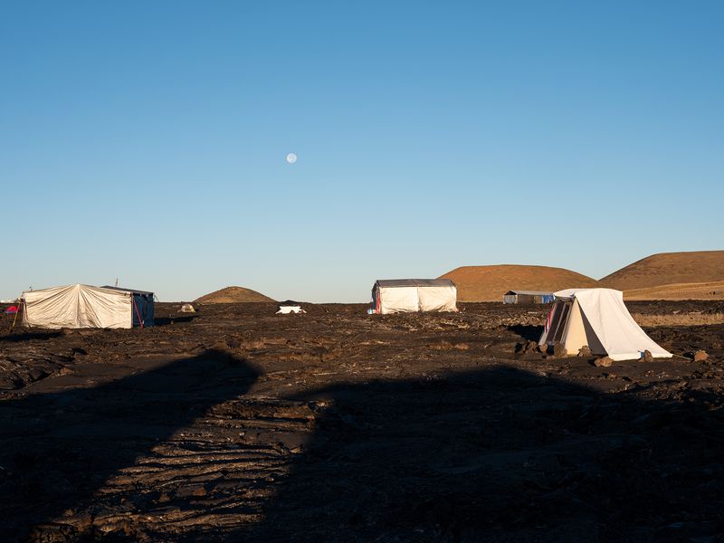 © Molly Peters - The full moon sets shortly after sunrise in the camp.
