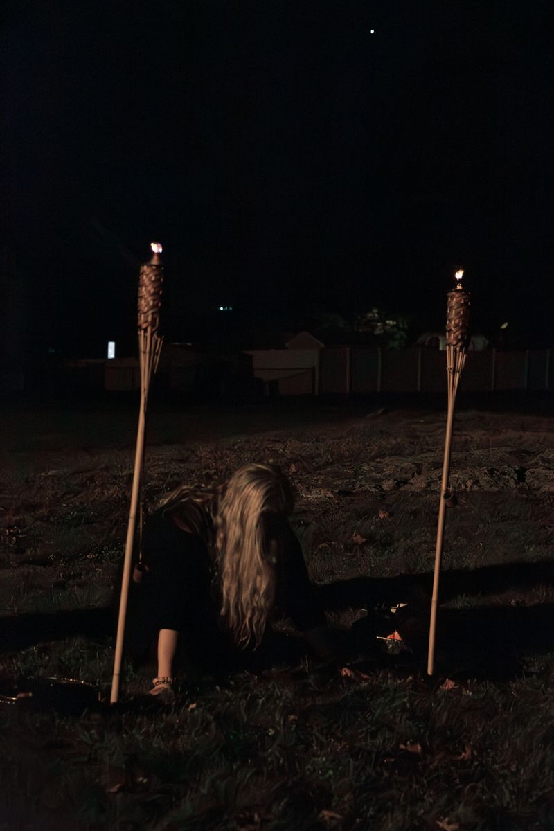 © Allison Stewart - Rev. Kathleen Rouleau kneeling at the portal, Salem, Massachusetts. 2023