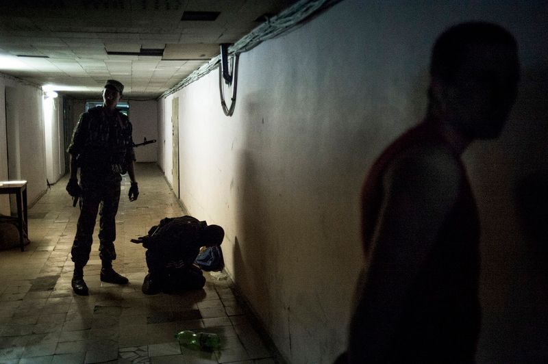 © Valery Melnikov - Rebels arrest a locals during a curfew