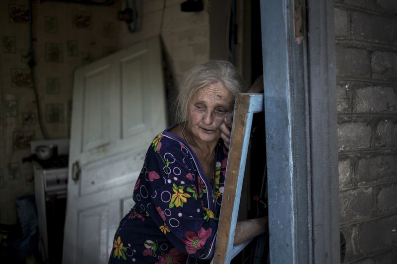 © Valery Melnikov - Local resident Galina Lobach, 67, in the village of Luhanskaya after the air attack
