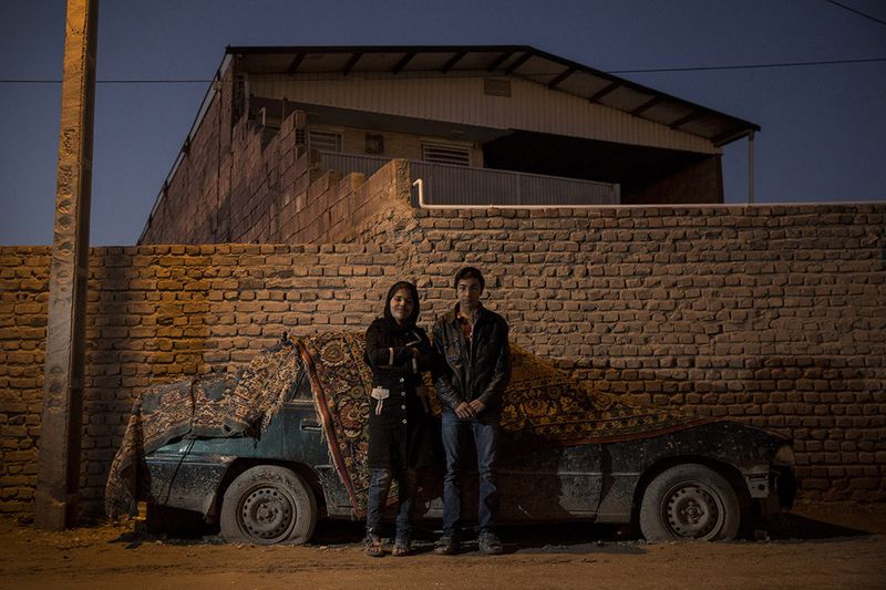 © Nazanin Tabatabaee Yazdi - Behzad and Zeinab are standing near their house.