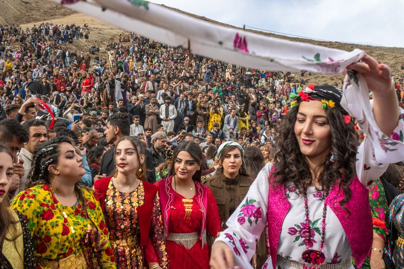 © Farbod Bavehie - Men and women dance side by side during a public Nowruz gathering.