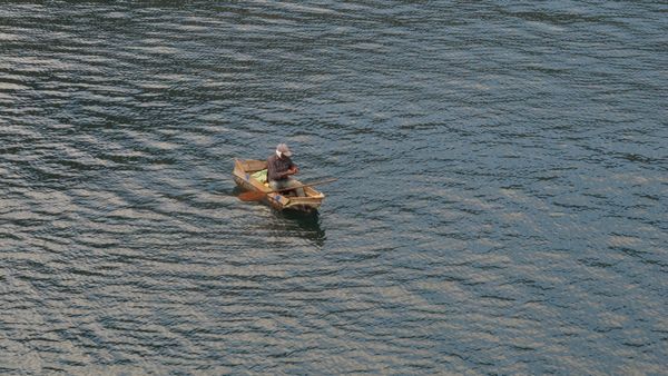 © Cristina Erdmann - "Fisherman" Lake Atitlán, Guatemala, 2016. Mayan fisherman in his traditional wooden canoe.
