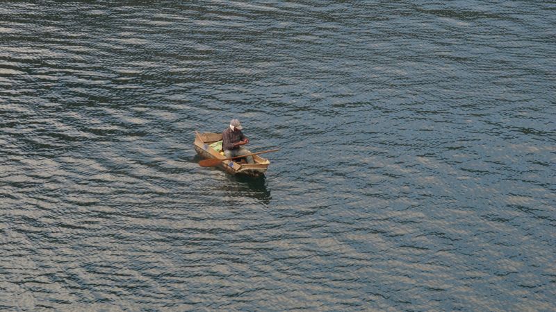 © Cristina Erdmann - "Fisherman" Lake Atitlán, Guatemala, 2016. Mayan fisherman in his traditional wooden canoe.