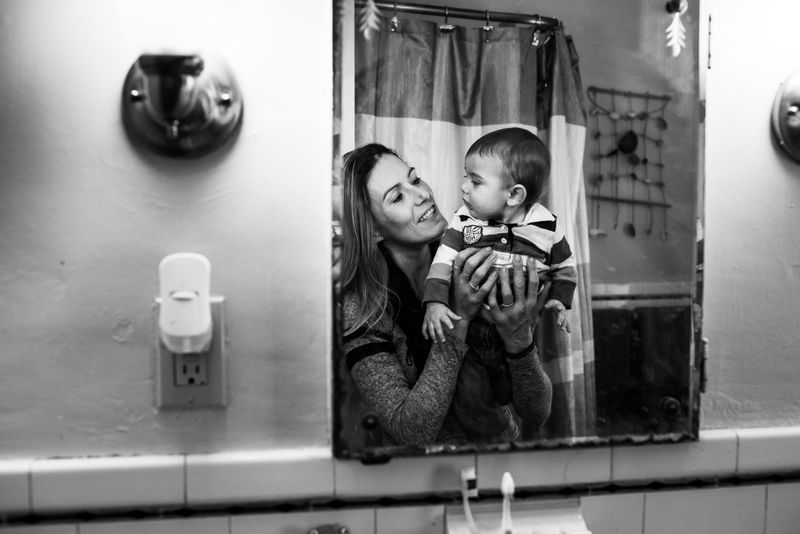 © Matilde Simas - Cary holds her son Jay, in her home in Portland, Maine.