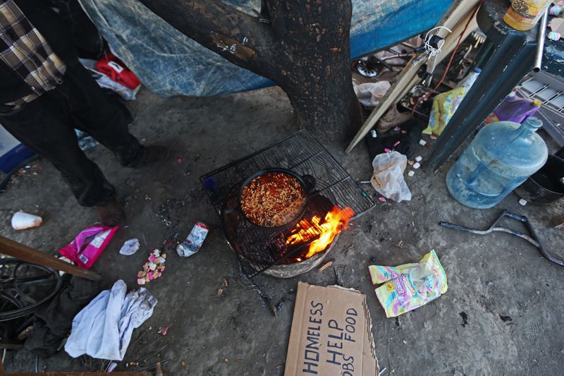 © Richard Street - Residents of the "Tumbleweed Hotel" prepare an evening meal on Sunday afternoon during the melon harvest. 3/26/16