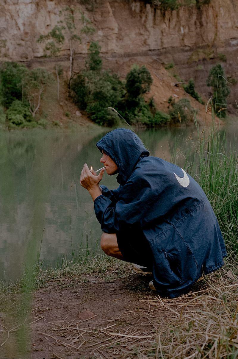 © Tajette O'halloran - A man lights up a cigarette on the bank