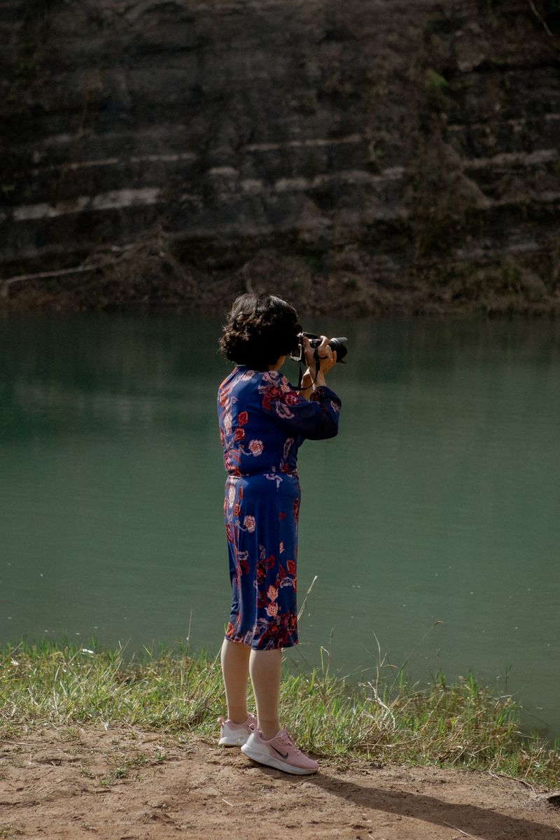 © Tajette O'halloran - A Japanese woman taking photos of swimmers