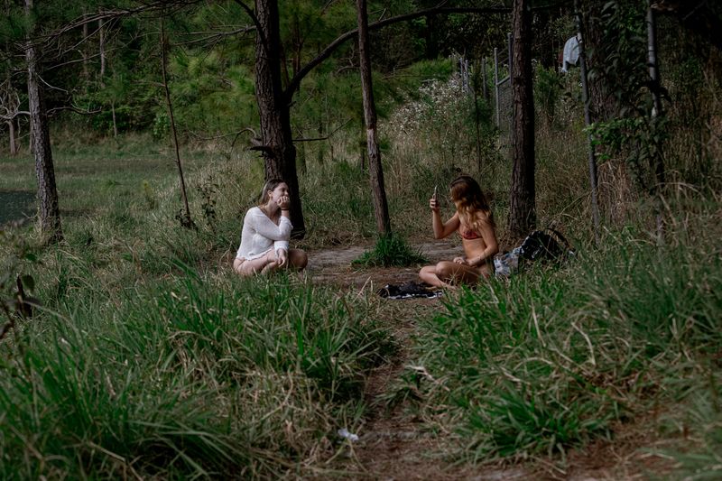 © Tajette O'halloran - A girl takes a photo of her friend on her mobile phone