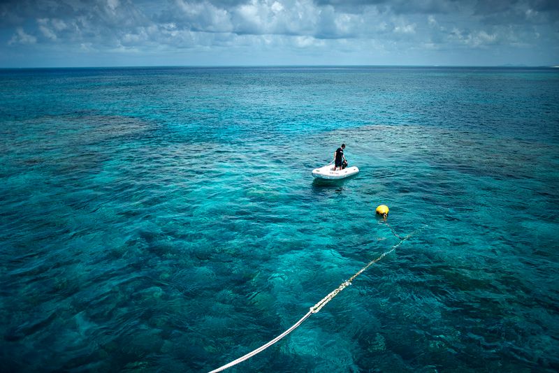 © Giacomo d'Orlando - An operator of Tusa6 is checking from the ocean surface the tourists who are diving through the Hamilton Reef.