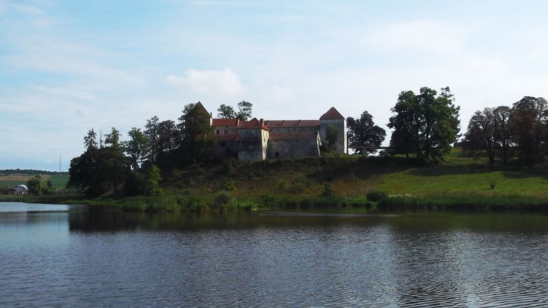© Andrei  Kolyaskin - Lake  and   Svirzh  Castle  from  15th  century  in   village  Svirzh  of  Lviv  region , Ukraine .