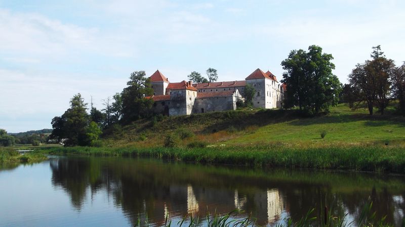 © Andrei  Kolyaskin - Lake  and   Svirzh  Castle  from  15th  century  in   village  Svirzh  of  Lviv  region , Ukraine .