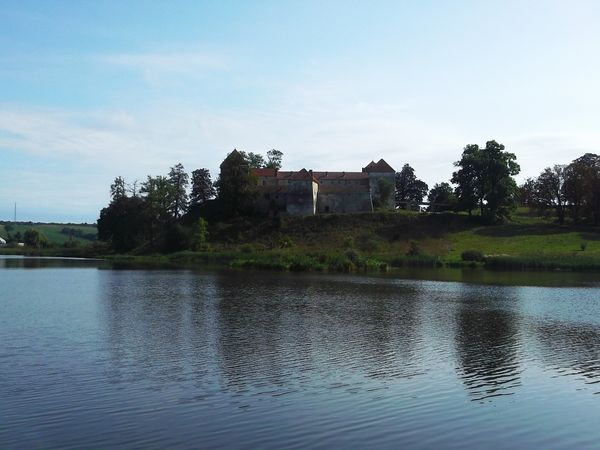 © Andrei  Kolyaskin - Lake  and   Svirzh  Castle  from  15th  century  in   village  Svirzh  of  Lviv  region , Ukraine .