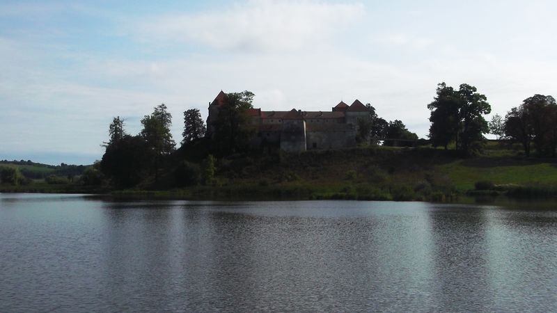 © Andrei  Kolyaskin - Lake  and   Svirzh  Castle  from  15th  century  in   village  Svirzh  of  Lviv  region , Ukraine .