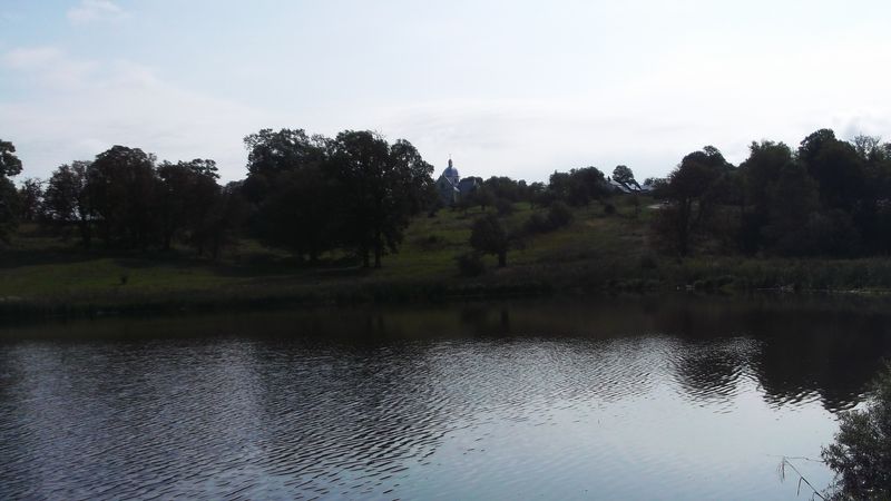© Andrei  Kolyaskin - Lake  and   territory  of   Svirzh  Castle  from  15th  century  in   village  Svirzh  of  Lviv  region , Ukraine .